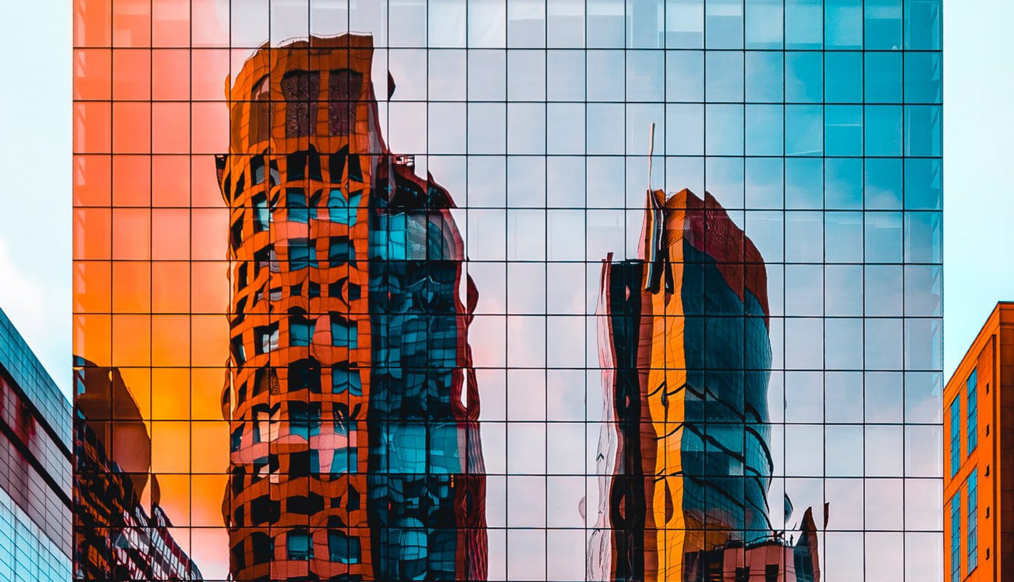 Yellow buildings reflected in mirrored windows