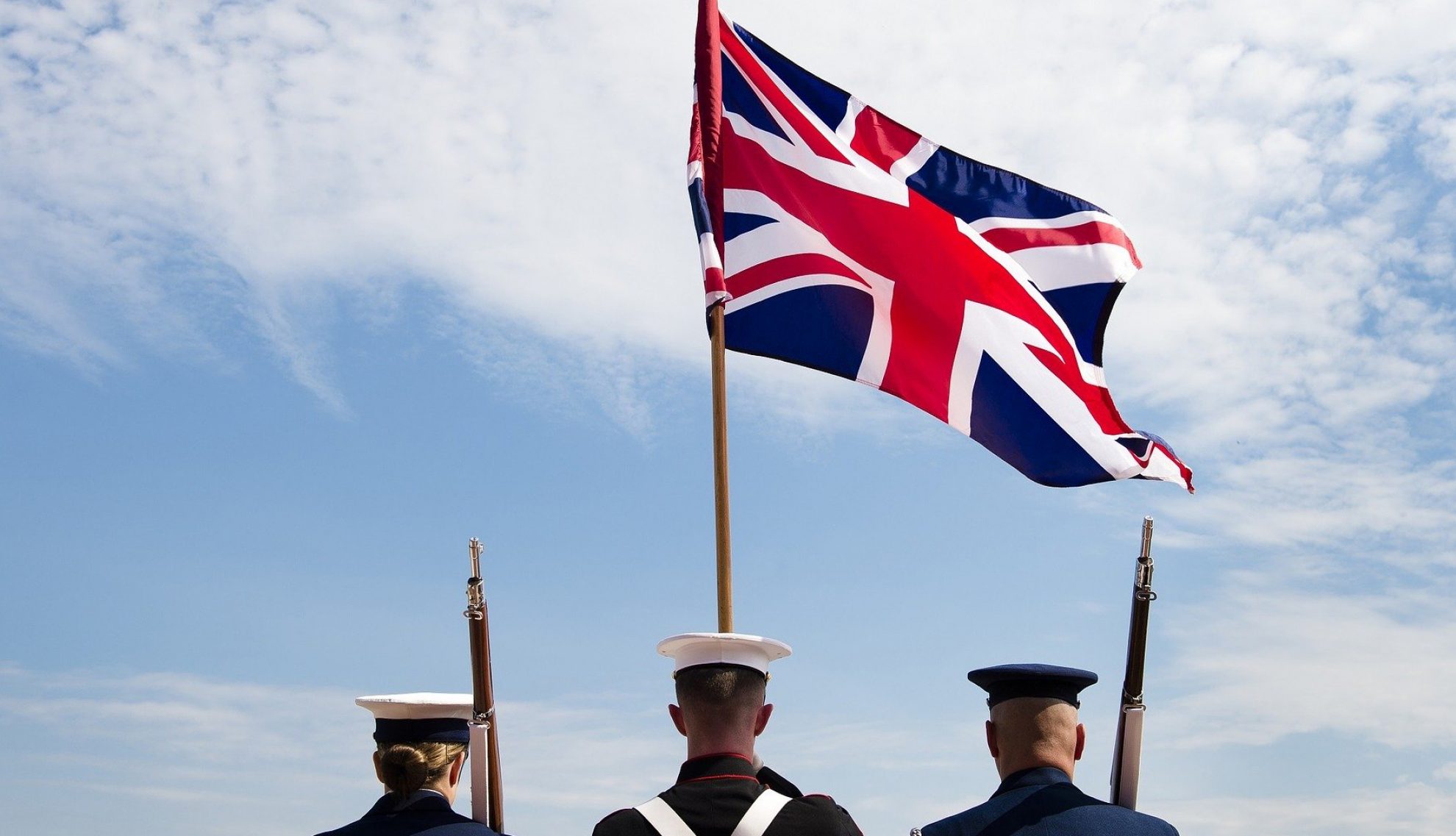 UK armed services personnel with Union Jack flag