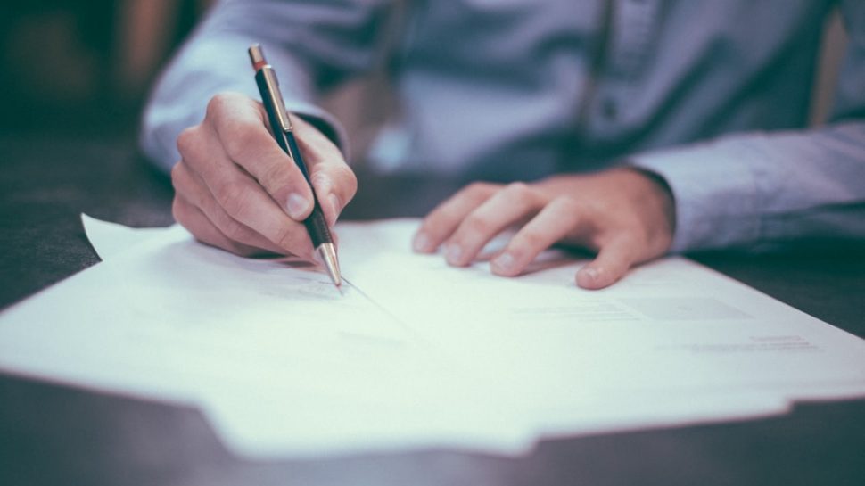 Someone signing a help to buy document
