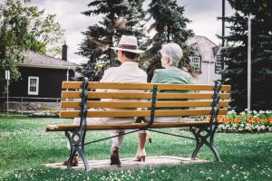 Old couple sitting on a bench 