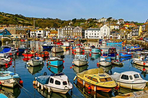 A harbour with colourful boats in Cornwall, South West England