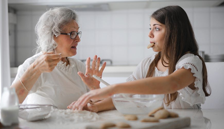 Elderly lady baking with a young girl
