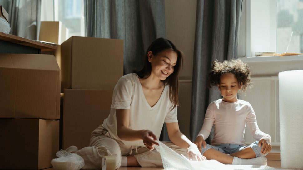 Mother and daughter packing boxes.
