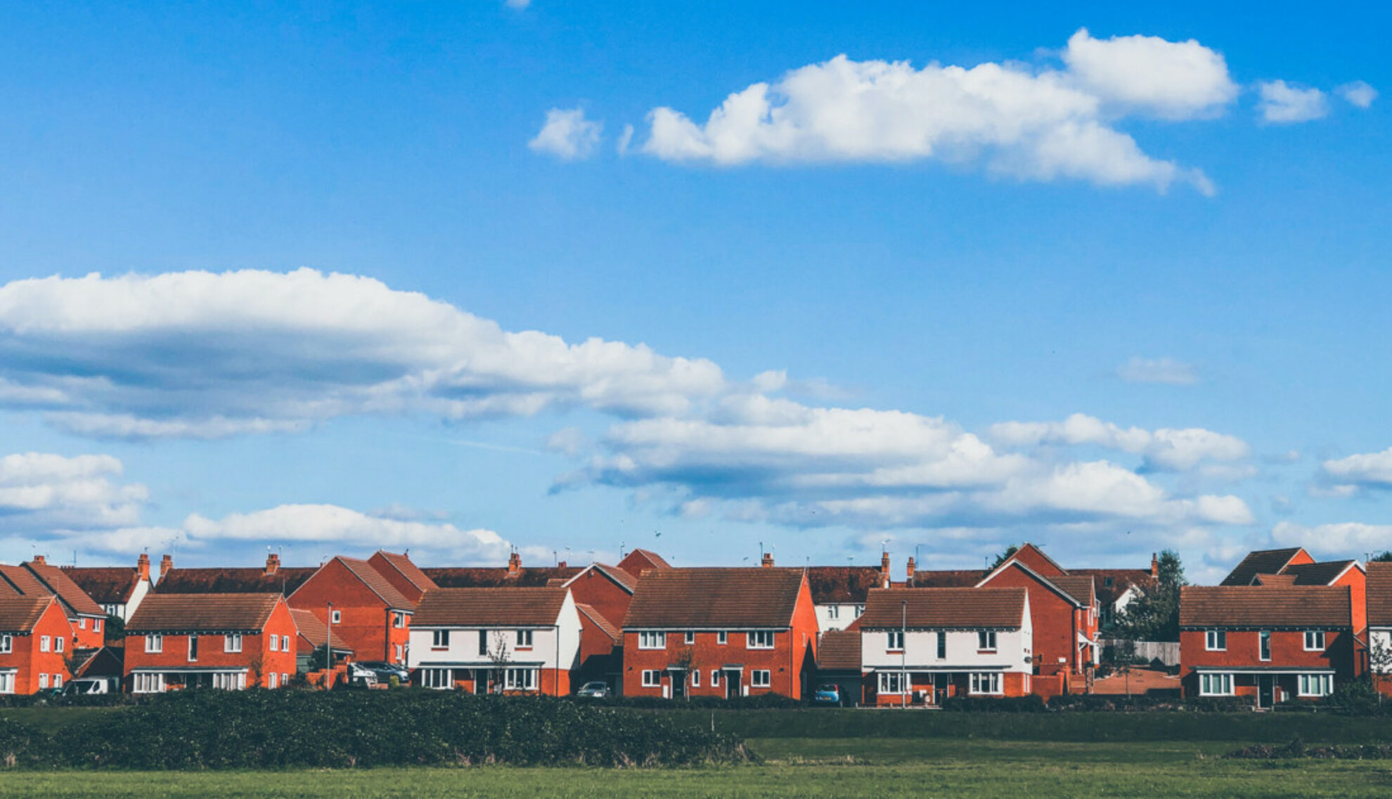 UK new build houses under a blue sky