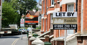 Row of rental houses with 'to let' signs outside